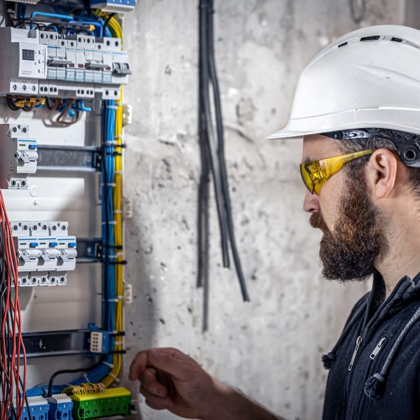 a male electrician works in a switchboard with an 2021 12 09 15 31 08 utc.jpg